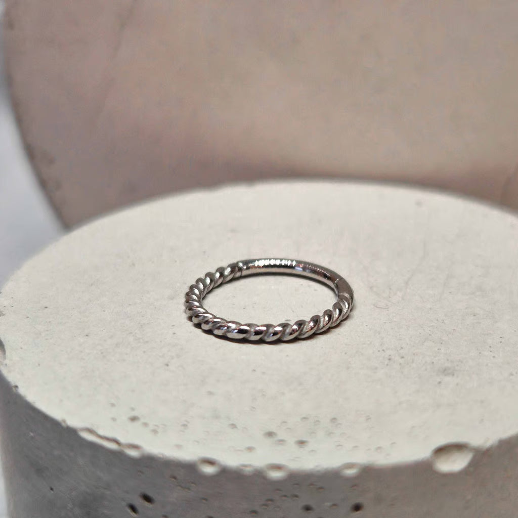 Hinged twisted segment ring